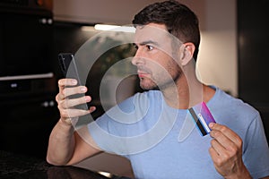 Man using his credit card to shop online