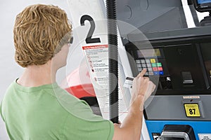 Man Using His Debit Card To Pay For Gasoline At Pump photo