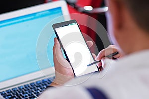 Man using his smartphone and tablet on the conference. Business