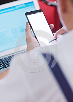 Man using his smartphone and tablet on the conference. Business