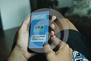 man using his smartphone, with the text chatbot