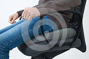 man using an inflatable ring cushion