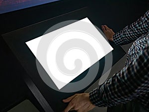 Man using interactive white empty touchscreen display kiosk at exhibition