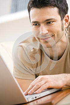 Man using laptop computer at home