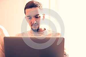 Man using laptop computer in living room