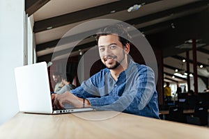 Man using laptop computer in office