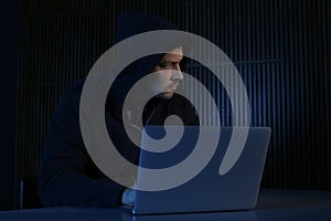 Man using laptop in dark room