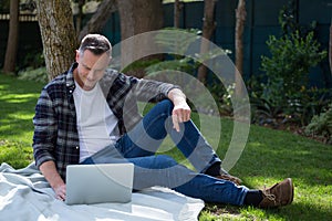 Man using laptop in garden