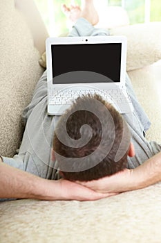 Man using laptop in home