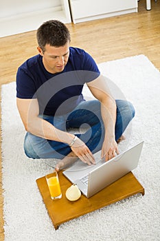 Man using laptop at home