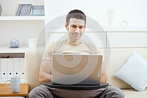 Man using laptop at home