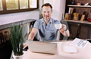 Man using laptop in kitchen