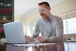 Man using laptop in living room