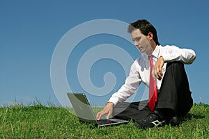 Man using laptop outdoors