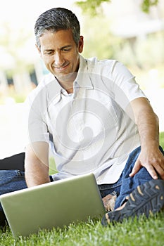 Man using laptop outdoors