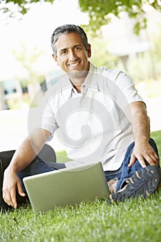 Man using laptop outdoors