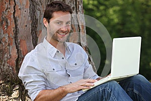 Man using laptop outside