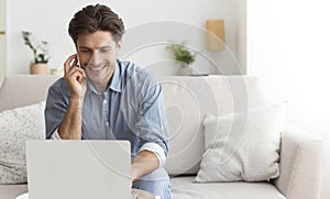 Man Using Laptop Talking On Cellphone With Customer Support Operator