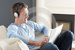 Man Using Laptop Wearing Headphones Relaxing