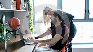 Man using laptop while woman embracing him from behind 4k