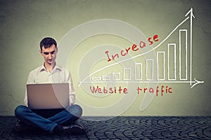 Man using laptop working on a plan to increase website traffic. Technology marketing concept
