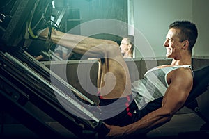 Man using leg press in gym
