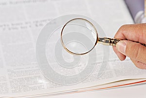 Man using magnify glass looking for jobs