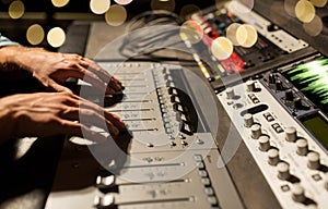 Man using mixing console in music recording studio