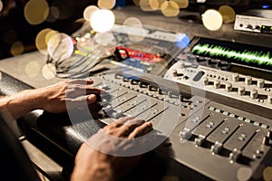 Man using mixing console in music recording studio