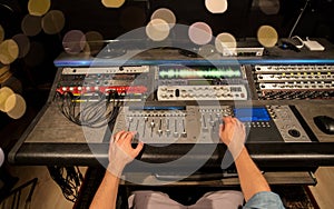 Man using mixing console in music recording studio