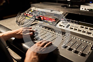 Man using mixing console in music recording studio