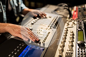 Man using mixing console in music recording studio