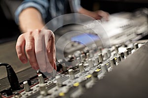 Man using mixing console in music recording studio photo
