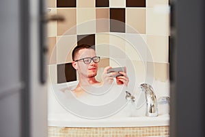 Man using mobile phone in the bathroom