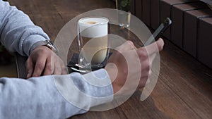 Man using mobile phone in cafe