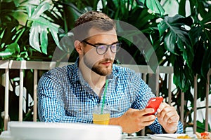 Man using mobile phone in a cafe