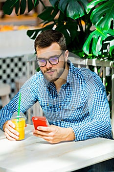 Man using mobile phone in a cafe