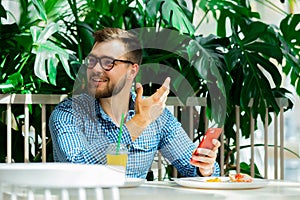 Man using mobile phone in a cafe