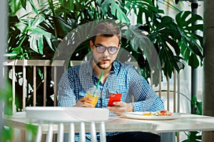 Man using mobile phone in a cafe