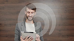 Man using mobile phone in cafe is happy hipster