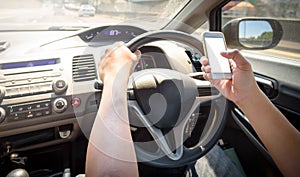 Man using mobile phone while driving a car