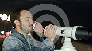 Man using mobile phone and looking into a tower