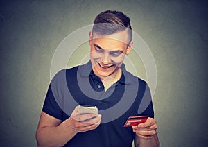 Man using mobile phone making online payment with credit card