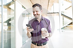 Man Using Mobile Phone In Shopping Mall