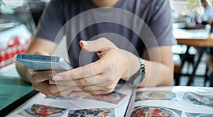 Man using mobile smart phone in restaurant