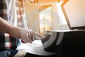 Man using modern multifunction printer in office, closeup