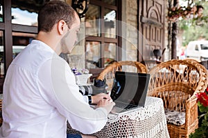 Man using a modern portable computer on an outdoor table