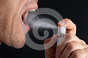 Man Using Mouth Freshener photo