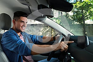 Man using navigation system while driving car