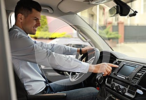 Man using navigation system while driving car